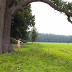 Pastoral Idyll II: A nude model is walking and dancing among the old oak and beech trees beside Ampsen castle, The Netherlands
