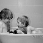 Playing in bath I: Two children are playing in bath