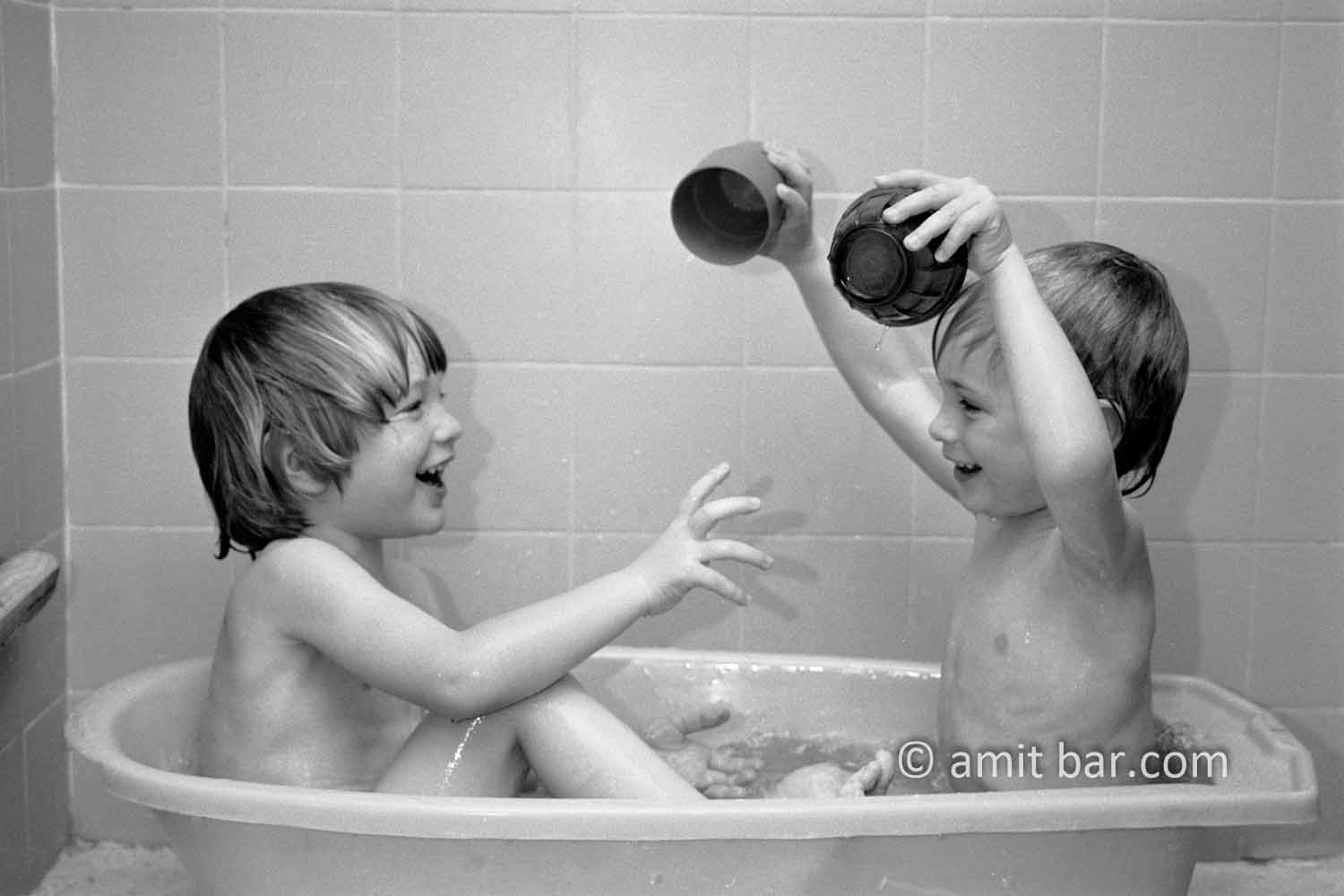 Playing in bath II: Two children are playing in bath
