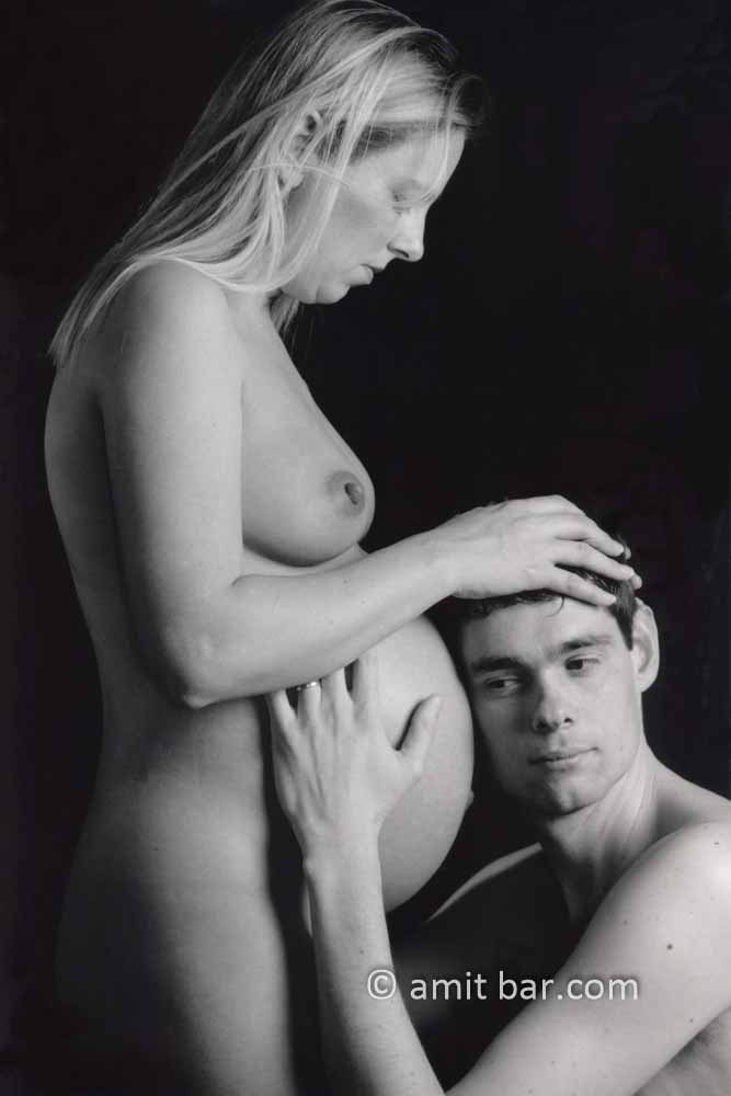 Pregnancy II: A husband listens to his pregnant wife's belly