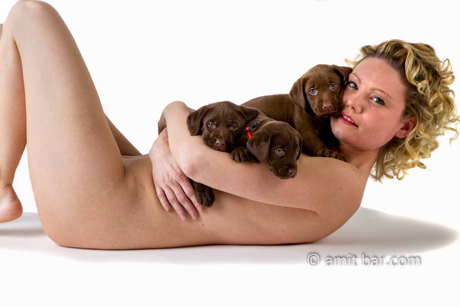 Puppies: Nude model with three puppies