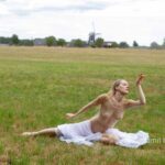 Radmila's vitrage III: Model Radmila is dancing and waving with vitrage in the field