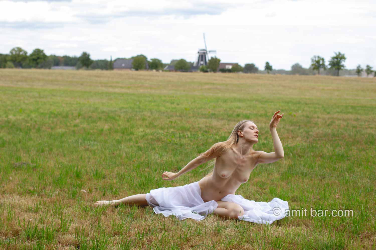 Radmila's vitrage III: Model Radmila is dancing and waving with vitrage in the field