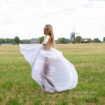 Radmila's vitrage IV: Model Radmila is dancing and waving with vitrage in the field