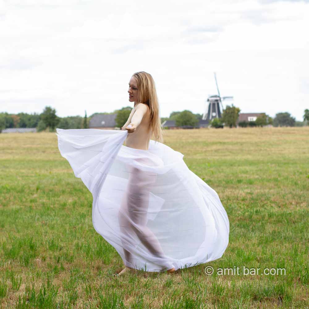 Radmila's vitrage IV: Model Radmila is dancing and waving with vitrage in the field