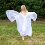 Radmila's vitrage V: Model Radmila is dancing and waving with vitrage in the field