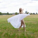 Radmila's vitrage VI: Model Radmila is dancing and waving with vitrage in the field