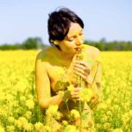 Rapeseed girl II: body-painted model in rapeseed field