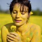 Rapeseed girl IV: body-painted model in rapeseed field