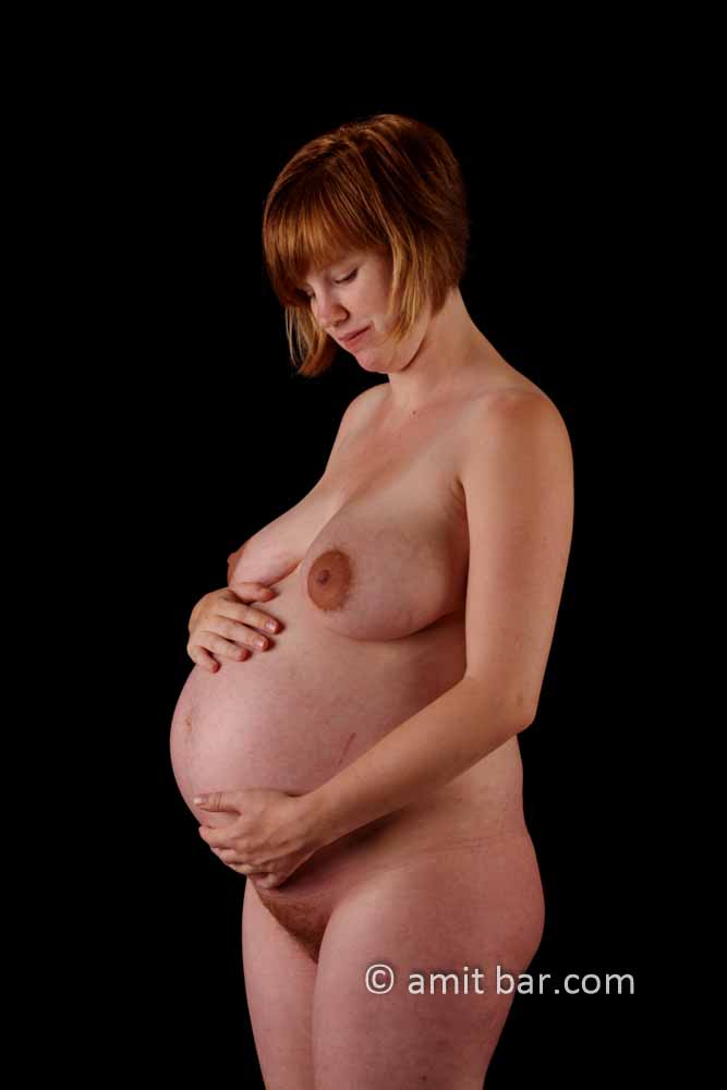 Reddish pregnancy: expecting. Nude pregnant woman with red hair