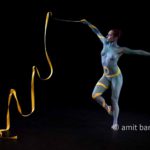 Ribbon dance I: Body-painted dancer with yellow ribbon