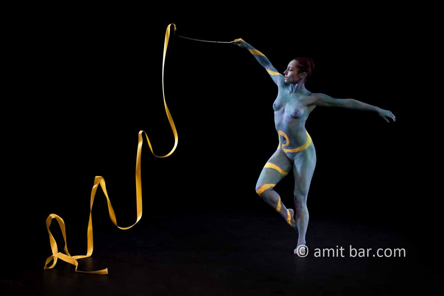 Ribbon dance I: Body-painted dancer with yellow ribbon