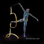Ribbon dance II: Body-painted dancer with yellow ribbon