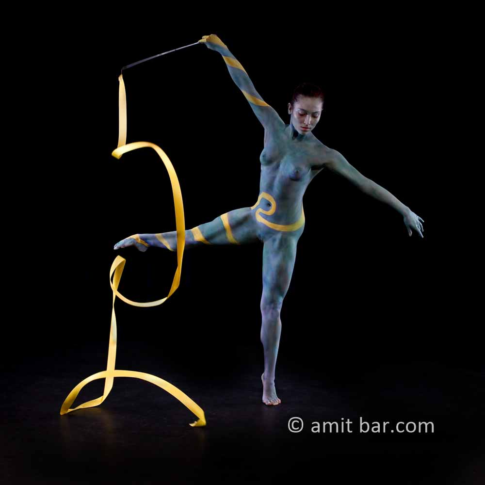 Ribbon dance II: Body-painted dancer with yellow ribbon