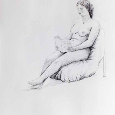 Seated nude reading a book