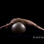 Streched V: Nude model streched on a white ball