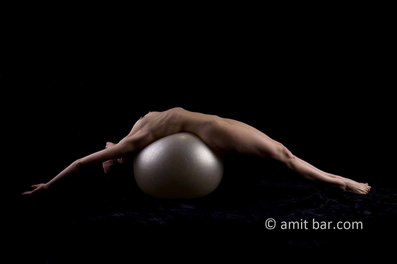 Streched V: Nude model streched on a white ball