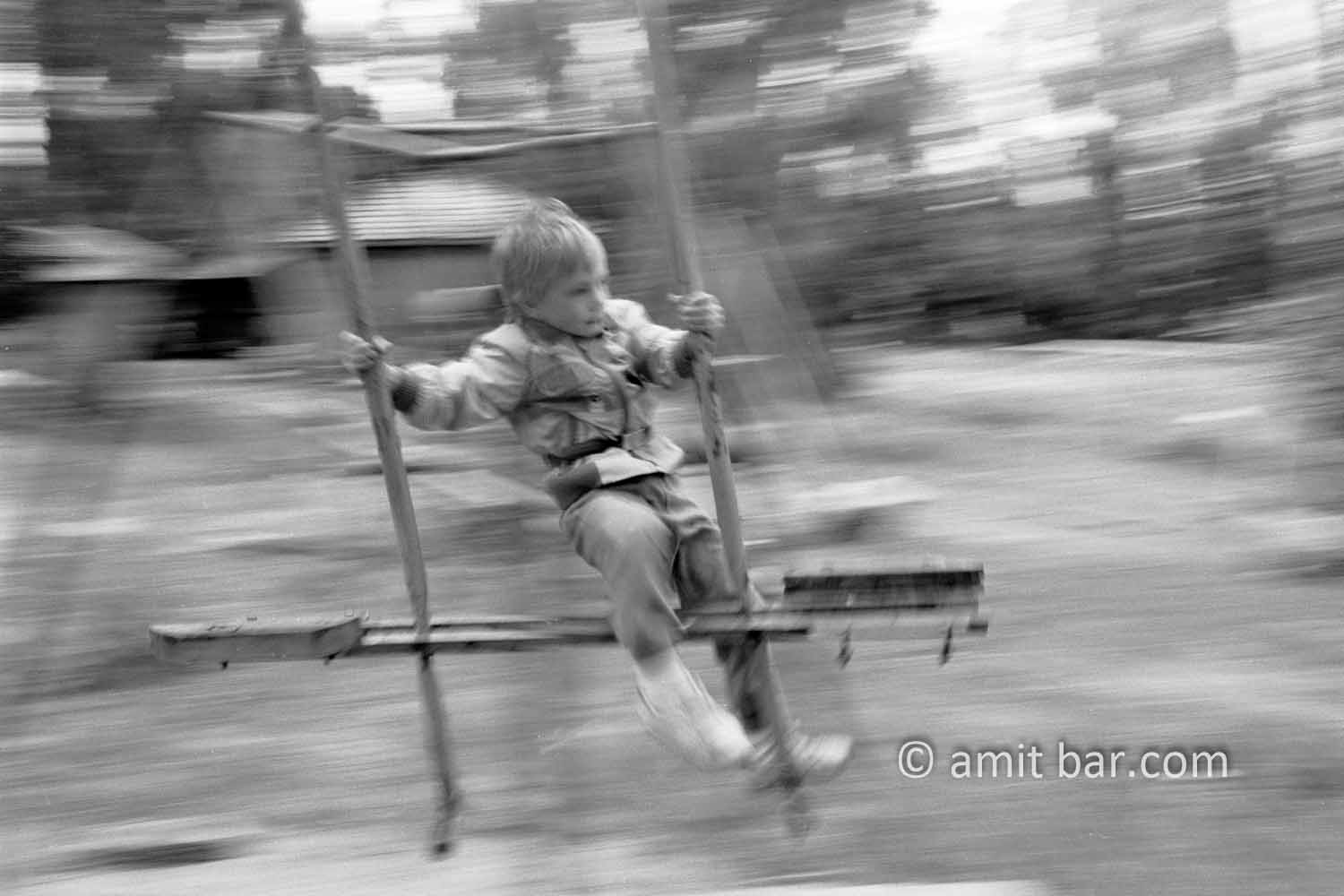 Swinging: Little boy is swinging on a swing