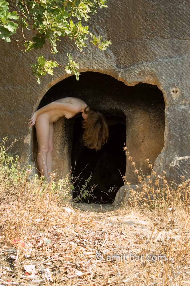 The cave: Nude model in a cave opening