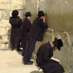The Wailing Wall: Four religious Jews are praying at the holy wall in Jerusalem