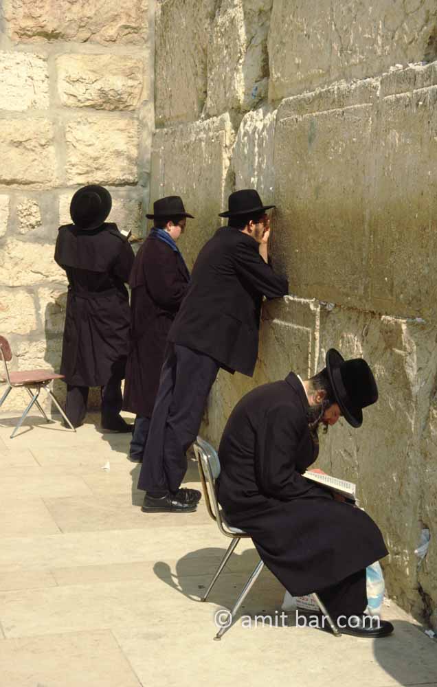 The Wailing Wall: Four religious Jews are praying at the holy wall in Jerusalem