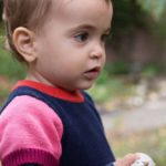 This little bird: A girl holding a bird toy in her hand