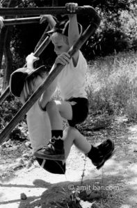 Upstairs, downstairs: Two boys swinging