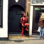 Who's afraid of the devil I: An actor dressed as a devil is chasing a girl on street theater festival in Doetinchem, The Netheralnds