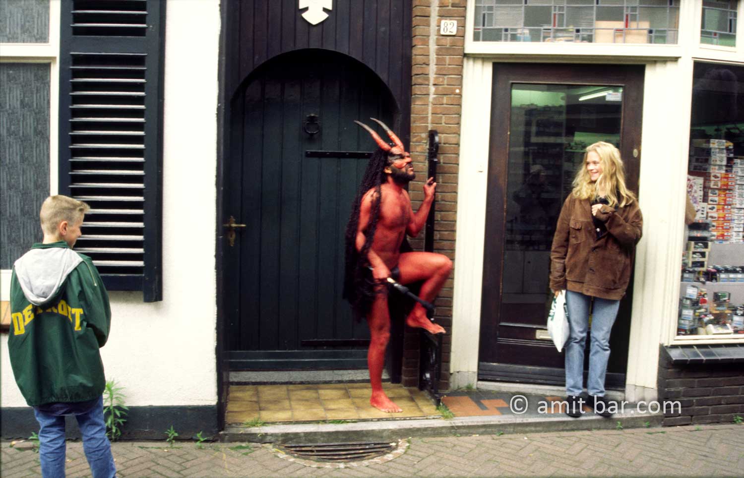 Who's afraid of the devil I: An actor dressed as a devil is chasing a girl on street theater festival in Doetinchem, The Netheralnds