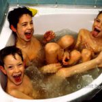 Wow!: Three boys in a corner bath